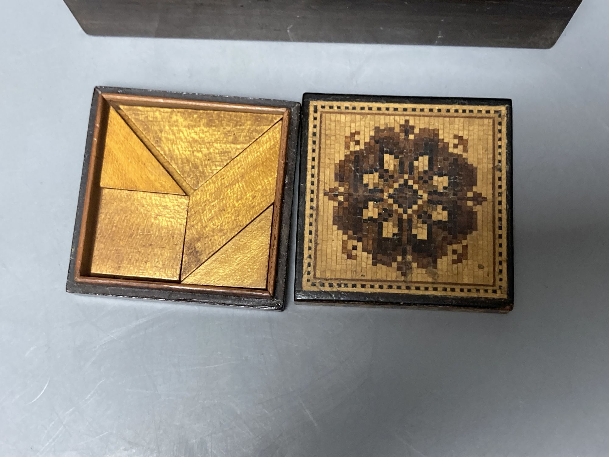 A Tunbridge ware mosaic lidded tangram puzzle and a half square mosaic box with inner tray, mid 19th century, 5cm and 11.6cm (2)